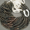 String of dark brown beads on a gray background