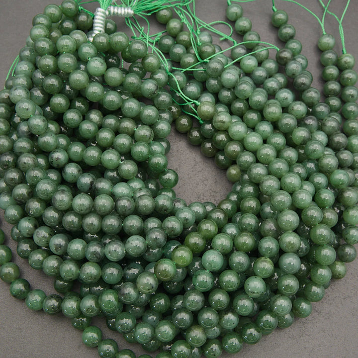 Green beads on a string against a gray background