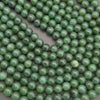 Close-up of green beads on a gray background