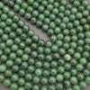 Close-up of green beads on a gray background
