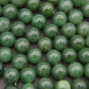 Close-up of green beads on a dark background