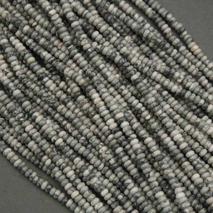 Close-up of a string of gray beads on a dark background