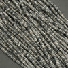 Close-up of a string of gray beads on a dark background