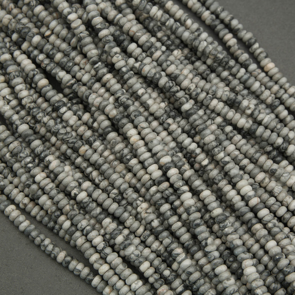 Close-up of a string of gray beads on a dark background