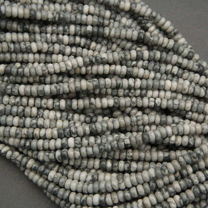 Close-up of a string of gray and white beads on a gray background