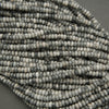 Close-up of a string of gray and white beads on a gray background