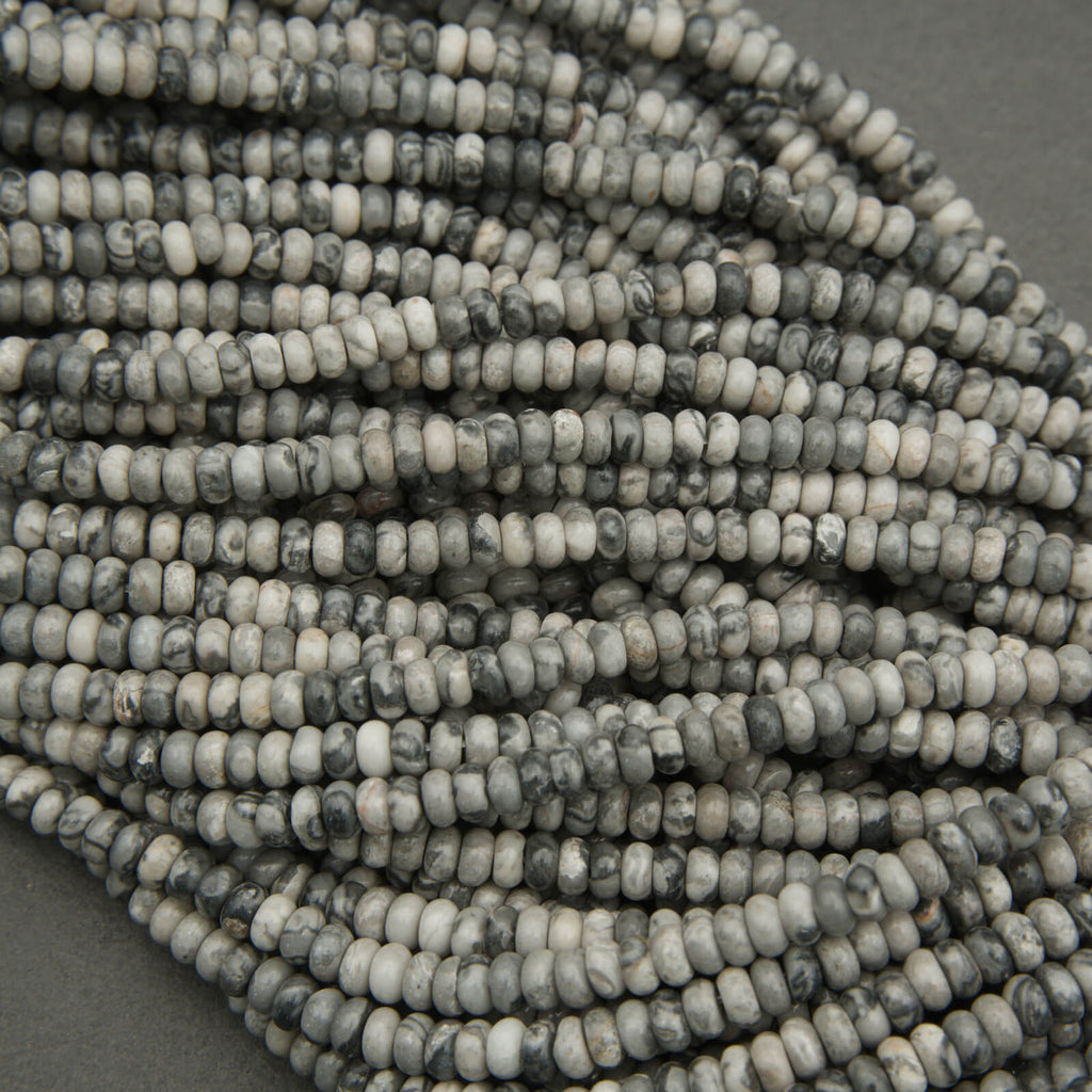 Close-up of a string of gray and white beads on a gray background