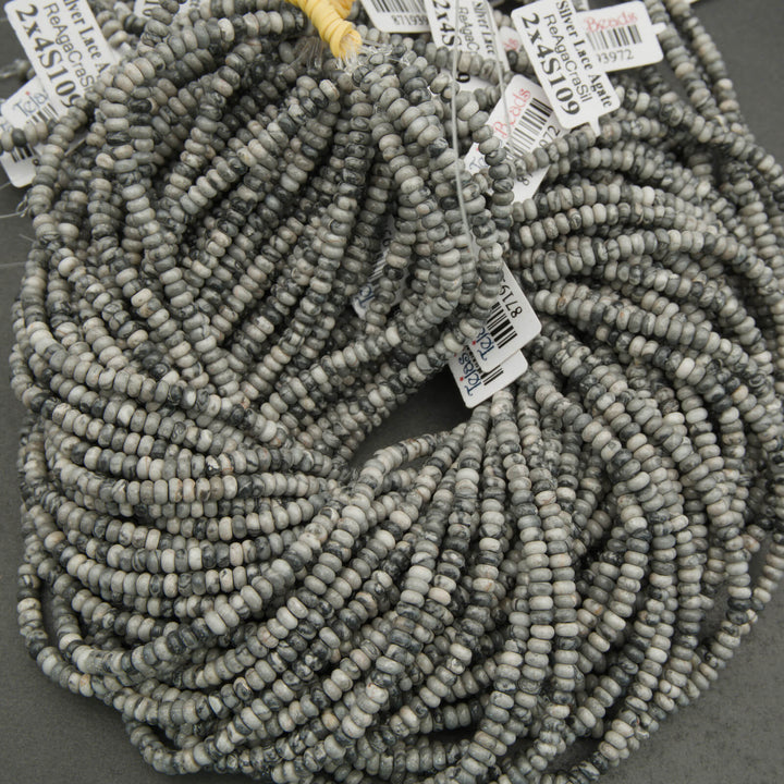 String of gray beads with price tags on a dark background