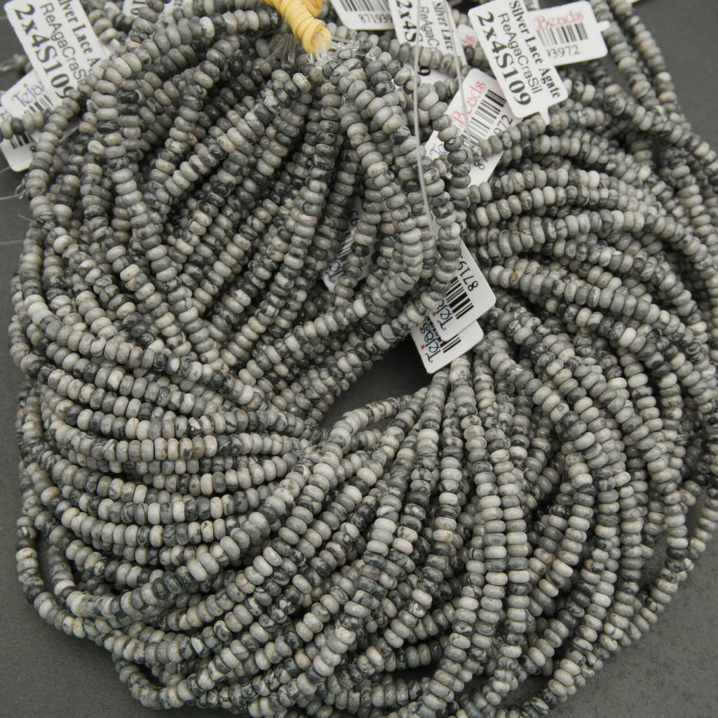 String of gray beads with price tags on a dark background