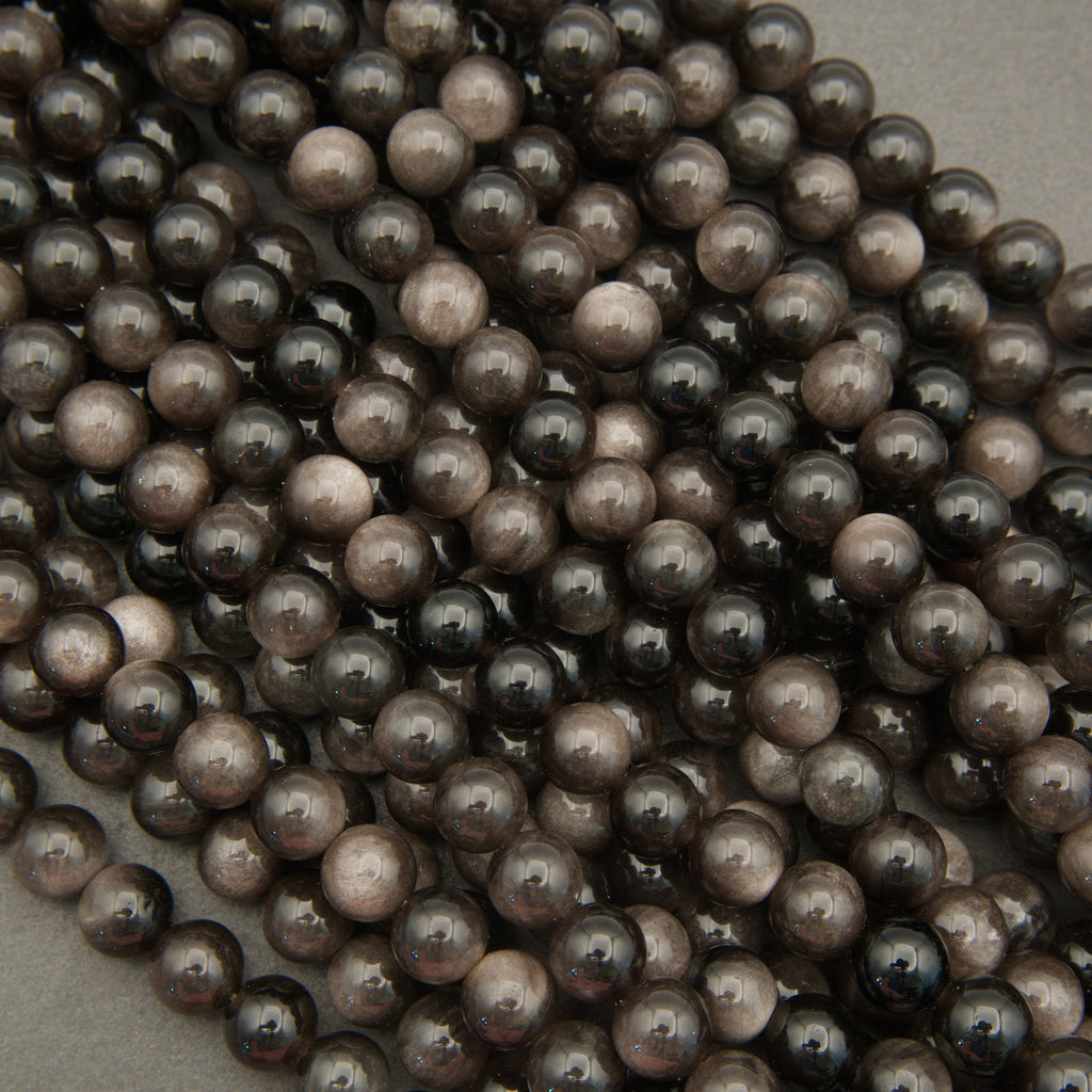 Close-up of dark brown pearls on a light gray background