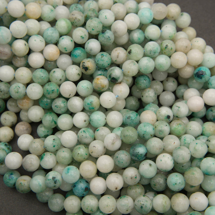 Strands of smooth round Sky Mountain Jade beads in white, mint and teal green