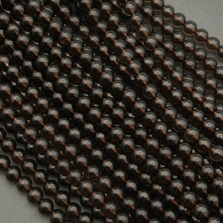 Close-up of dark brown metallic beads on a gray background