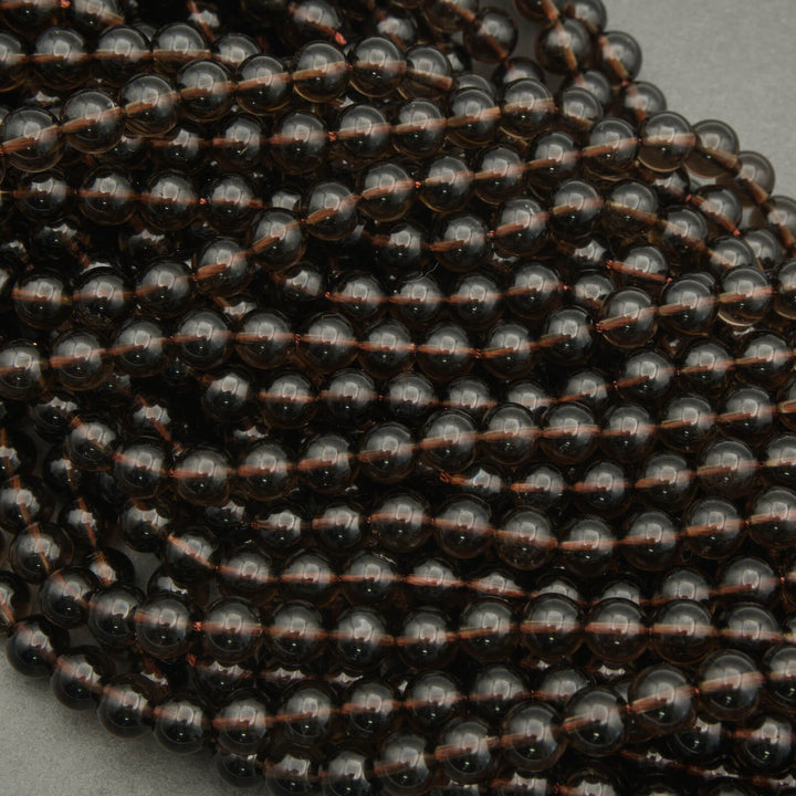 Close-up of a string of black beads on a gray background