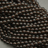 Close-up of a string of black beads on a gray background