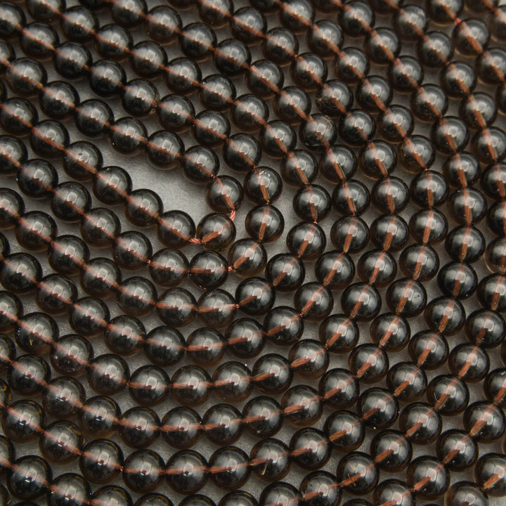 Close-up of black beads with copper accents arranged in a pattern.