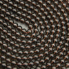 Close-up of black beads with copper accents arranged in a pattern.