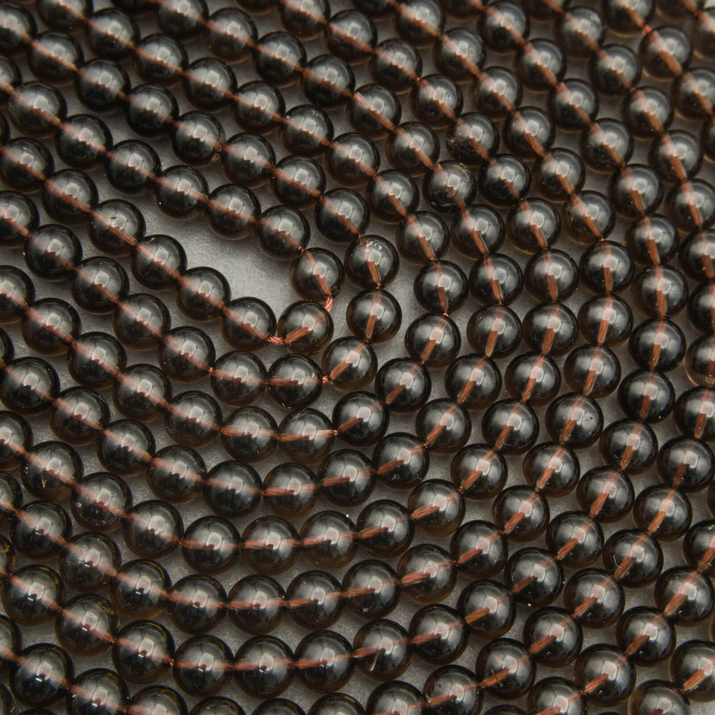 Close-up of black beads with copper accents arranged in a pattern.