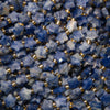 Close-up of faceted snowflake sodalite star beads showing blue and white patches and checkerboard facets