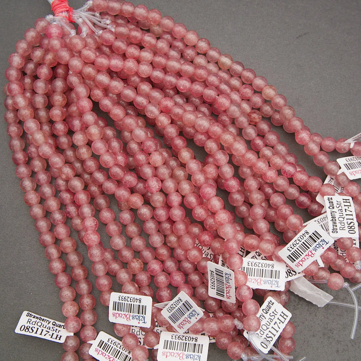 String of pink beads with price tags on a gray background
