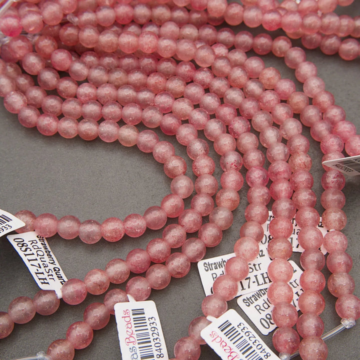 Polished Strawberry Quartz bead strand in pink tones