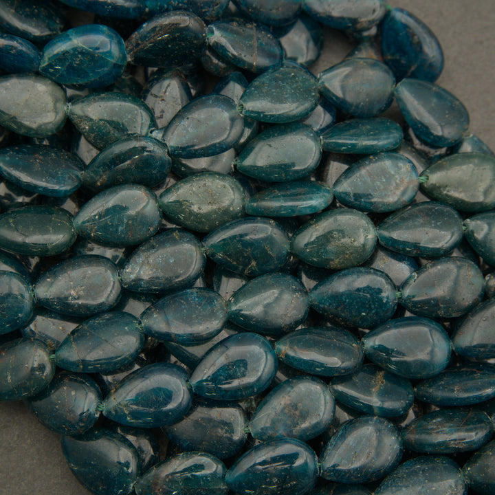 Close-up of blue teardrop-shaped stones on a gray background