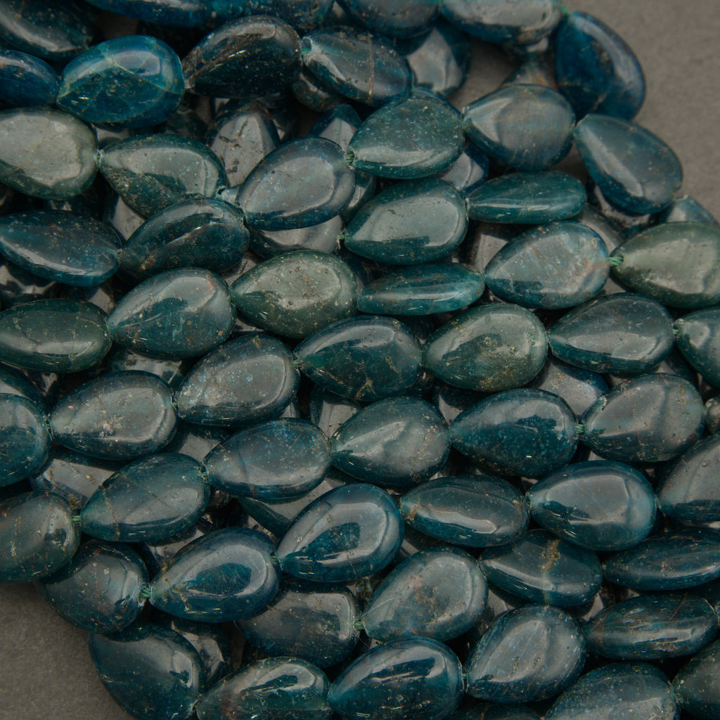 Close-up of blue teardrop-shaped stones on a gray background