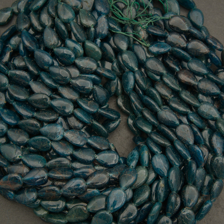Close-up of dark blue pebbles on a gray surface