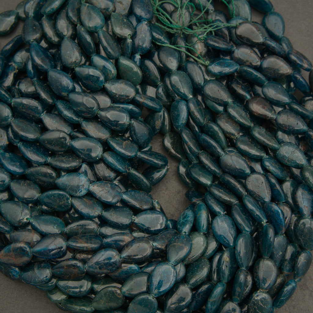 Close-up of dark blue pebbles on a gray surface