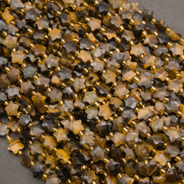 A heap of faceted tiger's eye star bead strands in golden honey and chocolate brown with gold seed bead spacers