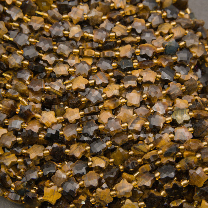 Strands of faceted tiger's eye star beads with silky golden stripes and a few blue-gray stars