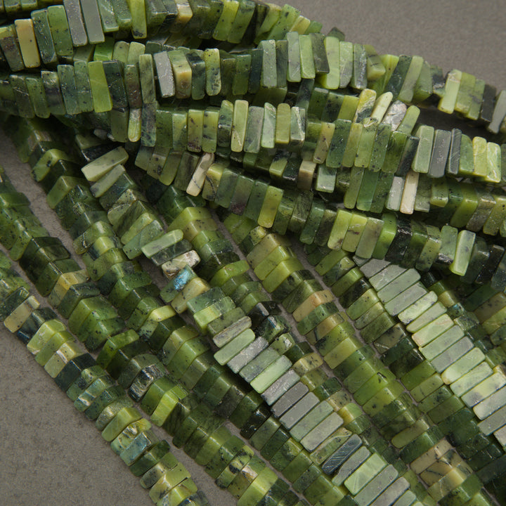 Close-up of green bead strands on a gray background
