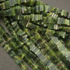 Close-up of green bead strands on a gray background