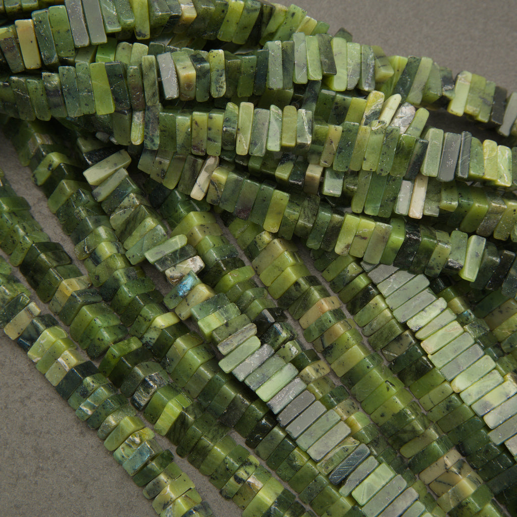 Close-up of green bead strands on a gray background