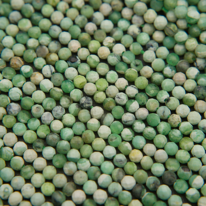 Close-up of microfaceted variscite beads showing mint green, cream and dark matrix spots