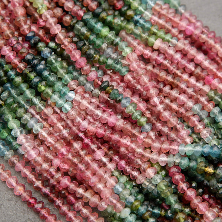 Close-up of multicolored bead strings on a gray background