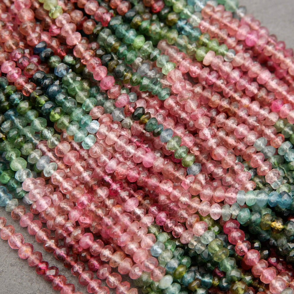 Close-up of multicolored bead strings on a gray background