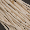 Ivory colored elongate tube shape beads.