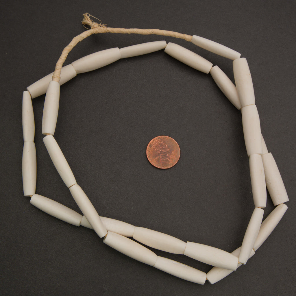Ivory colored elongate tube shape beads.