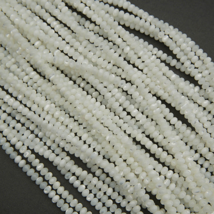 Close-up of white beads on a dark background