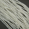 Close-up of white beads on a dark background