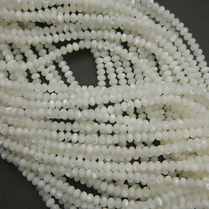 Close-up of a string of white beads on a dark background