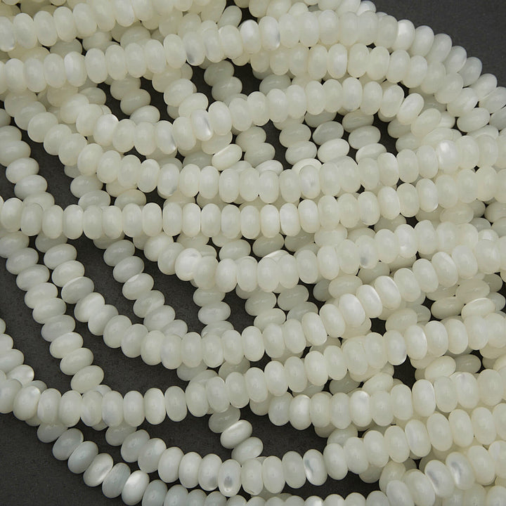 Close-up of white seed beads on a dark background