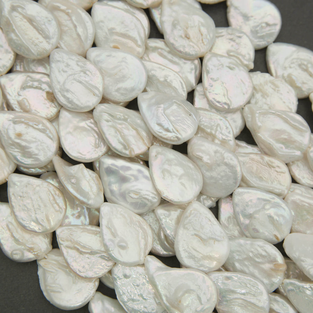 Close-up of white pearls on a dark surface