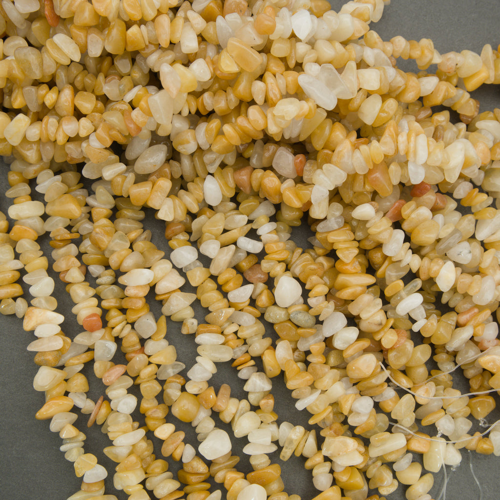 Close-up of small yellow and white stones on a gray background