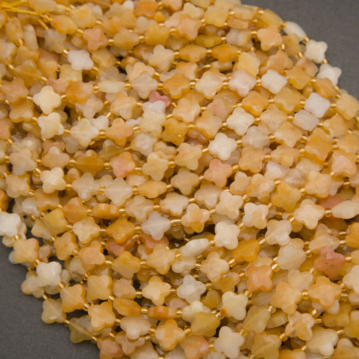 Natural yellow jade beads displaying honey-yellow, pale peach, and buttery cream shades.