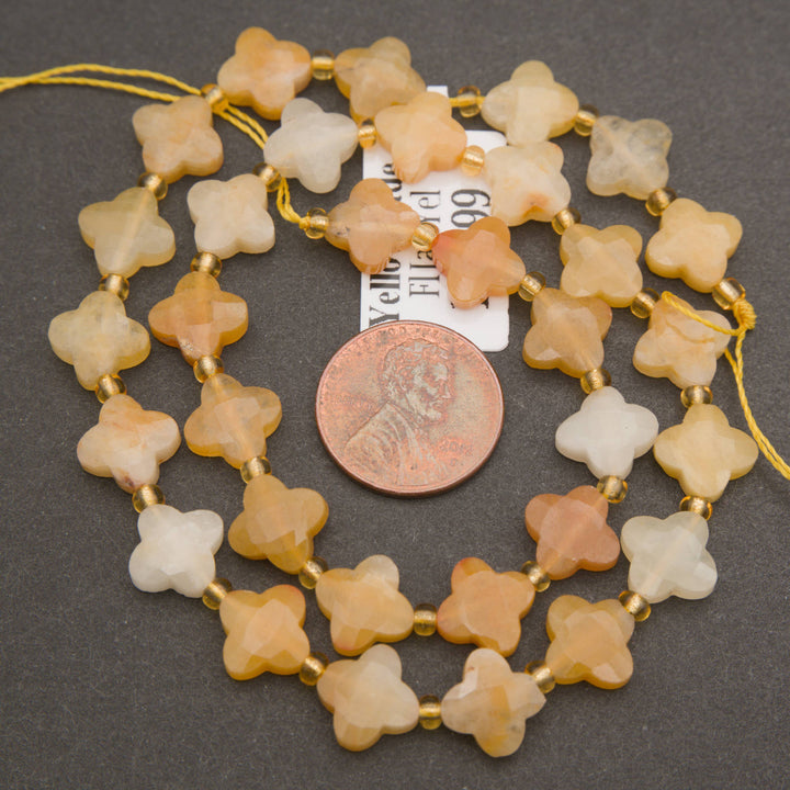 Strands of yellow jade flower beads featuring warm golden hues and softly translucent surfaces.