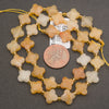 Strands of yellow jade flower beads featuring warm golden hues and softly translucent surfaces.