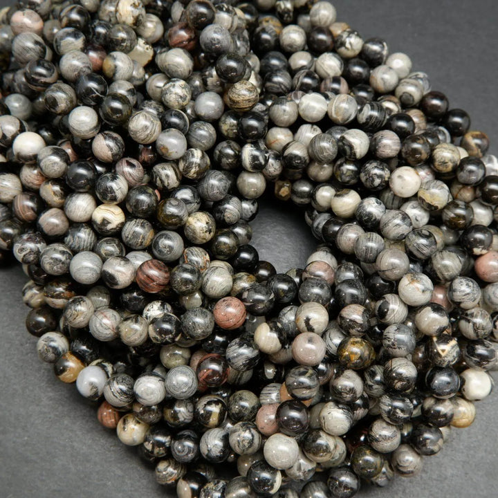 Black silver leaf jasper smooth polished round beads.