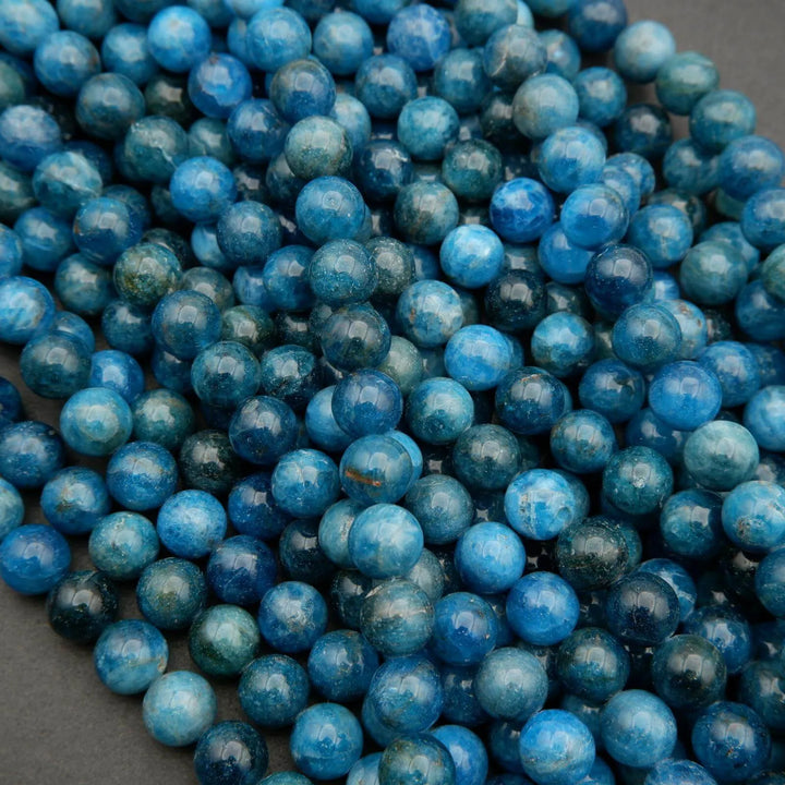 Round polished blue apatite beads.