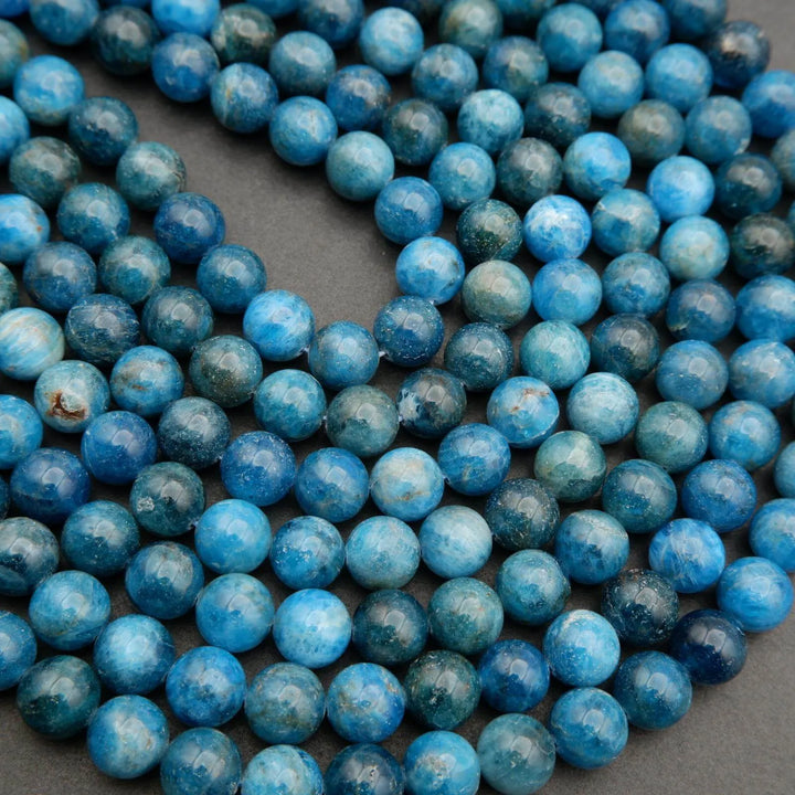 Round polished blue apatite beads.